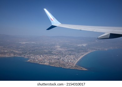 Costa Blanca, Spain 1 May 2022: Wing Of Tui Airplane In Flight Over The Coastline Of Coast Brava, Spain