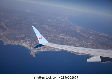 Costa Blanca, Spain 1 May 2022: Wing Of Tui Airplane In Flight, Flying Over The Coastline Of Coast Brava, Spain