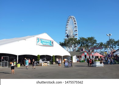 COSTA MESA, CALIFORNIA - AUG 8, 2019: Livestock Pavilion And Ferris Wheel At The Orange County Fair.