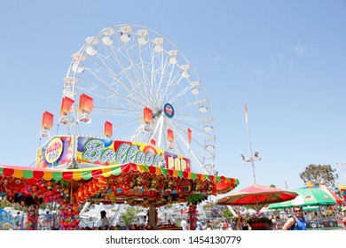 Costa Mesa, California/United States - 07/17/2019: A View Of A Giant Ferris Wheel And Carnival Game Tent Located At The Orange County Fair