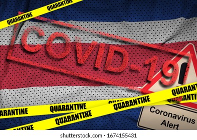 Costa Rica flag and Covid-19 quarantine yellow tape with red stamp. Coronavirus or 2019-nCov virus