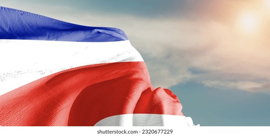Costa Rica national flag cloth fabric waving on beautiful Cloudy Background. - Shutterstock ID 2320677229
