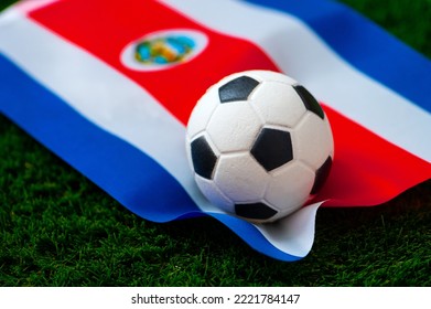 Costa Rica national football team. National Flag on green grass and soccer ball. Football wallpaper for Championship and Tournament in 2022. World international match. - Shutterstock ID 2221784147