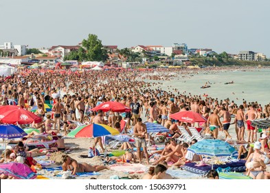 COSTINESTI, ROMANIA - AUGUST 11: Very Crowded Beach Full Of People At The Black Sea on August 11, 2013 in Costinesti, Romania. Costinesti is one of the most important resort at the Black Sea seashore.