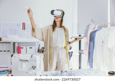 Costume designer using modern VR visual digital design technology in tailor studio - Powered by Shutterstock