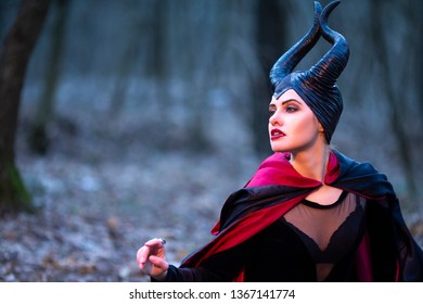 Costume Drama. Mysterious Maleficent Female Posing in Early Spring Forest. Horizontal Image Orientation