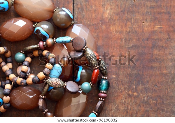 Costume Jewelry. Vintage female bracelets and\
necklace on wooden\
surface