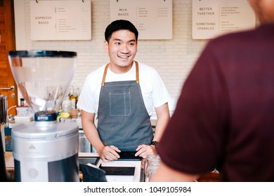 Costumer Order Asian Barista With Smile At Coffeeshop.