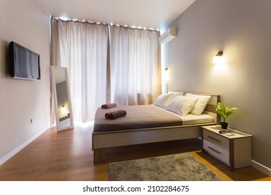 Cosy Bedroom Interior With White Bed Sheets And Closed Curtains