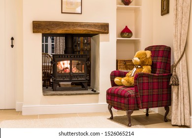 Cosy Fireplace With Wood Burning Stove And Teddy Bear In A Living Room Home Interior, UK