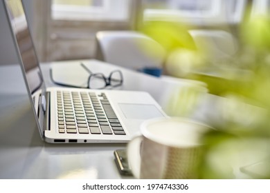 Cosy Home Office Desk With Laptop Computer. Still Life, No People.