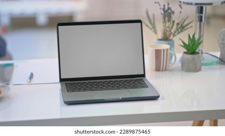 Cosy home office desk with laptop computer. Still life, no people, blank screen. - Shutterstock ID 2289875465