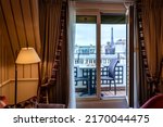 Cosy Paris hotel room with balcony and beautiful view at Eiffel tower and city