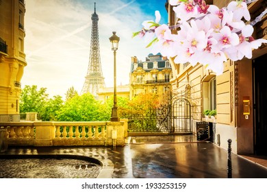 cosy Paris street with view on the famous Eiffel Tower on a cloudy spring day, Paris France