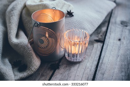 Cosy And Soft Winter Background, Knitted Sweater And Candles On An Old Vintage Wooden Board. Christmas Holidays At Home.