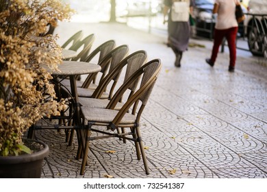 Cosy Street Cafe, Lined Up Table And Chairs, Side Walk.