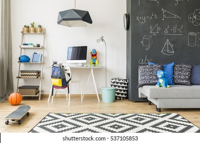 Cosy and well furnished bedroom with patterned carpet, blackboard wall and workplace - Powered by Shutterstock - Get 15% off with code: PIKWIZARD15