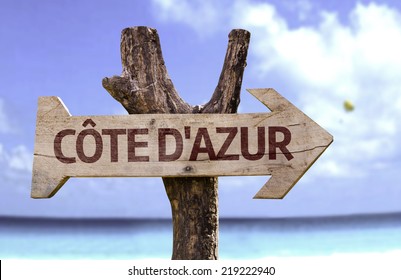 Cote Dazur Wooden Sign With A Beach On Background