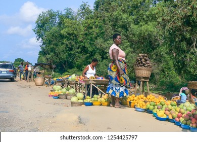 Cotonou, Benin - April 30, 2018: Local African Woman selling Fruits near the Road