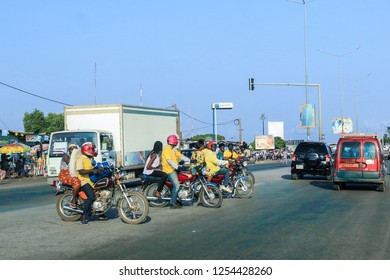 Cotonou, Benin - April 30, 2018: Local African Men on the Bikes near the Road