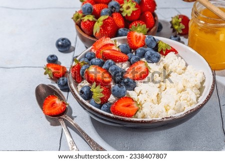 Cottage cheese with berries. Bowl of cottage cheese with strawberry, blueberry, high-protein summer healthy breakfast or lunch, copy space