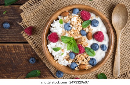 Cottage cheese for breakfast with granola, yogurt and fresh berries. Healthy breakfast. Top view