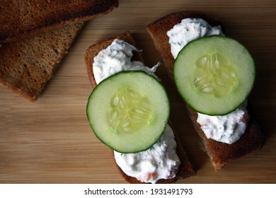 Cottage Cheese Dip With Cucumber Slices On Black Bread Toast. Breakfast. Space For Text.