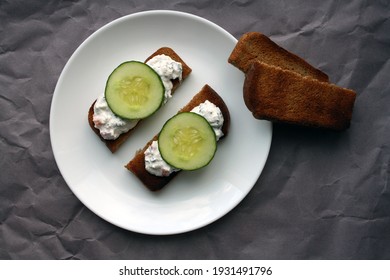 Cottage Cheese Dip With Cucumber Slices On Black Bread Toast. Breakfast. Space For Text.