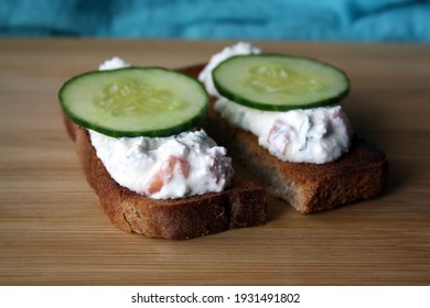 Cottage Cheese Dip With Cucumber Slices On Black Bread Toast. Breakfast. Space For Text.