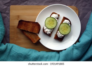 Cottage Cheese Dip With Cucumber Slices On Black Bread Toast. Breakfast. Space For Text.