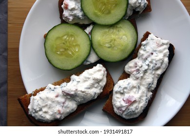 Cottage Cheese Dip With Cucumber Slices On Black Bread Toast. Breakfast. Space For Text.