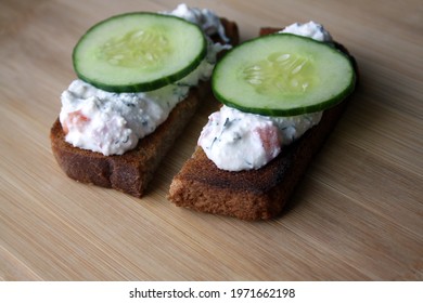 Cottage Cheese Dip With Cucumber Slices On Black Bread Toast. Breakfast. Space For Text.