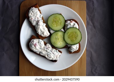 Cottage Cheese Dip With Cucumber Slices On Black Bread Toast. Breakfast. Space For Text.