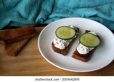 Cottage Cheese Dip With Cucumber Slices On Black Bread Toast. Breakfast. Space For Text.