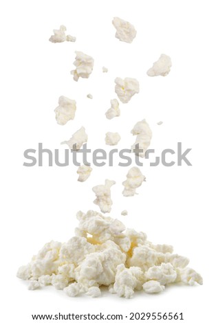 Cottage cheese drops on a heap close-up on a white background. Isolated