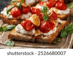 Cottage cheese and roasted tomatoes sourdough bread toast on a wooden board.