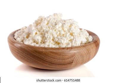 Cottage cheese in a wooden bowl isolated on a white background