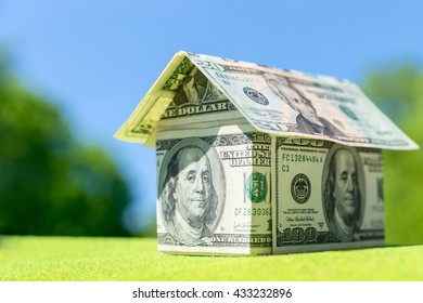 Cottage made of dollar banknotes, housing loan. Think green.