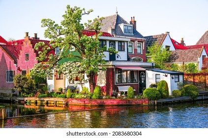 Cottage on the bank of the river canal. Cottage estate on river. River cottage view