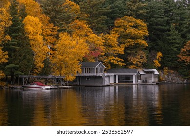 Cottages and boats by the lake with colorful fall trees in the background in Port Carling, Ontario, Canada. Fall season concept. - Powered by Shutterstock