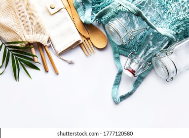 Cotton Bags, Net Bag With Reusable  Glass Jars, Bamboo And Wooden Cutlery On White Background. Zero Waste Concept. Eco Friendly. Flat Lay