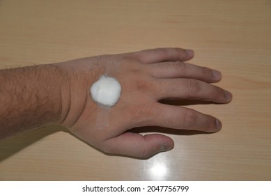 A Cotton Ball And Sanitary Tape Is Placed On The Arm And Hand Site Where Blood Was Drawn For A Medical Test  