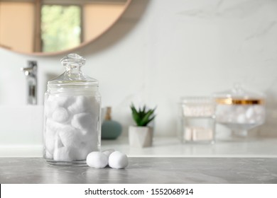 Cotton Balls On Light Grey Marble Table In Bathroom