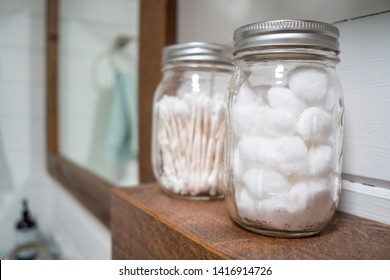 Cotton Balls And Cotton Swabs In Mason Jars On Farmhouse Bathroom Shelf.