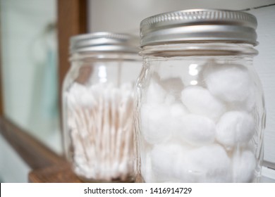 Cotton Balls And Cotton Swabs In Mason Jars On Farmhouse Bathroom Shelf.