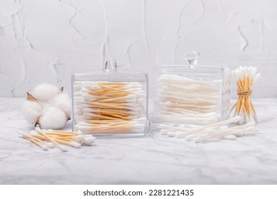 Cotton buds on a light concrete background.Eco-friendly materials. Wooden, cotton swabs on a white background.Bamboo swabs and cotton flowers.Zero waste, plastic free lifestyle concept.Place for text. - Shutterstock ID 2281221435