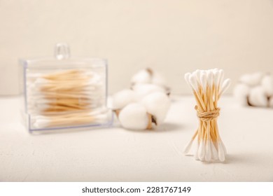 Cotton buds on a light concrete background.Eco-friendly materials. Wooden, cotton swabs on a white background.Bamboo swabs and cotton flowers.Zero waste, plastic free lifestyle concept.Place for text. - Shutterstock ID 2281767149
