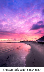 Cotton candy colors fill the sky during this sunset in Malibu.  Puffy clouds and calm waters add to the serene scenery.