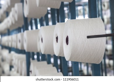 Cotton Cone Hang On Racks And The Cotton Threads Coming From These Reels And Combined Together