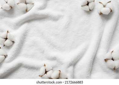 Cotton flowers on a white terry towel with copy space. - Shutterstock ID 2172666883